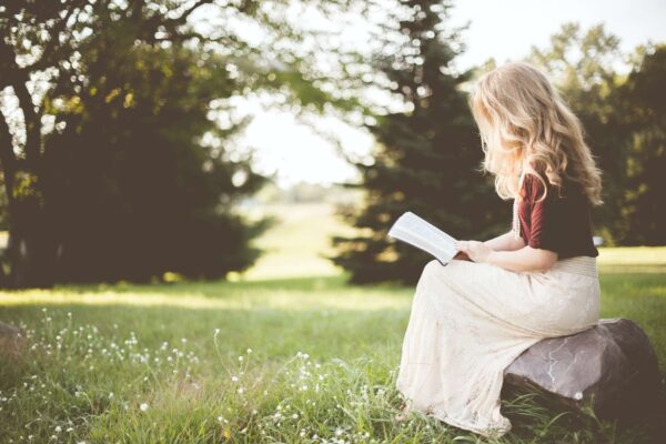 An image of a person reading a book comfortably