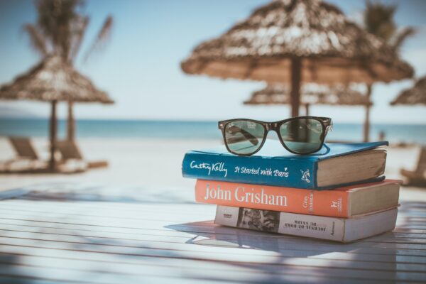 An Image of books on the desk on the beach